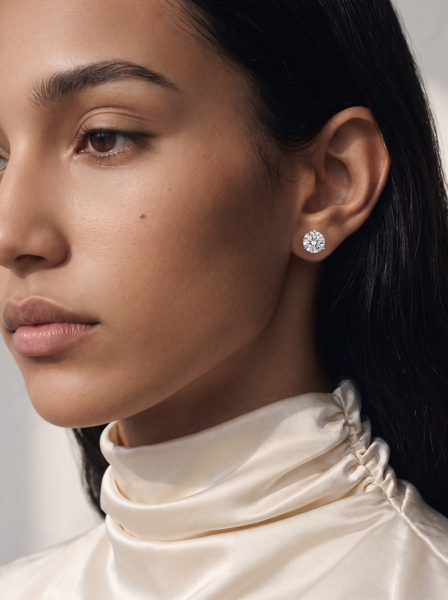 Model wearing Round Diamond Stud Earrings in 14K White Gold, 6.00 total carat pair (3.00 carats each)