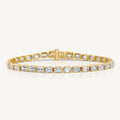 A yellow gold east west emerald cut diamond tennis bracelet by Harlow George